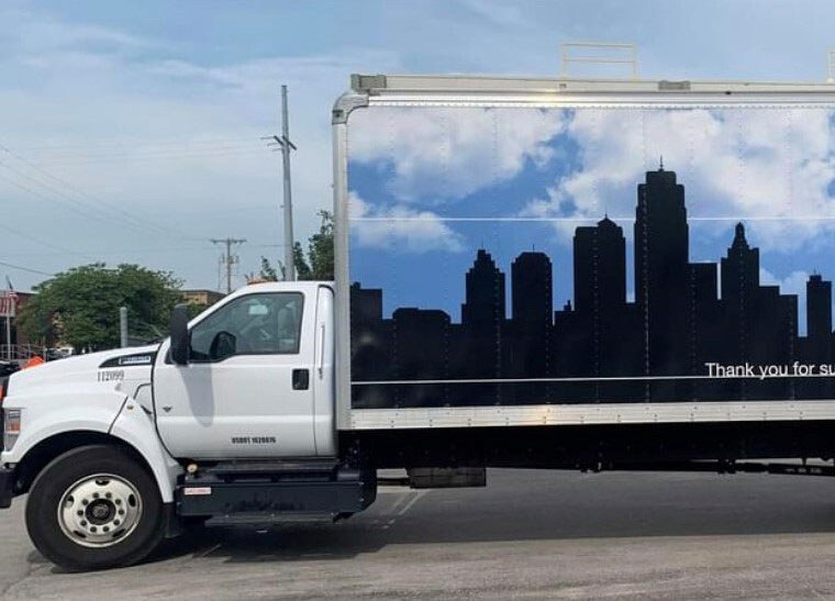 City Thrift donation truck wrapped with Kansas City skyline graphic