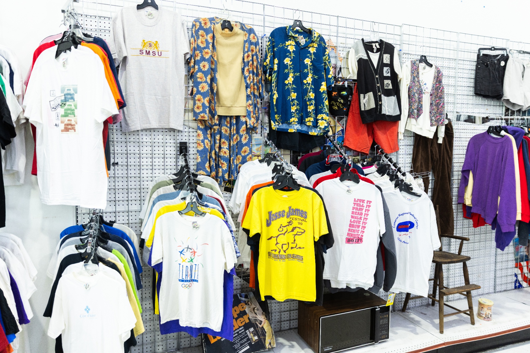 Curated racks of clothing inside a City Thrift store